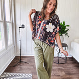 Lightweight olive smocked waist pants with side pockets and knee darts, cropped style.
