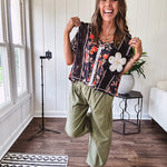 Lightweight black V neck tee with coral rose floral print throughout, raw seams and black ace inserts and ivory floral crochet patchwork on the front pocket.
