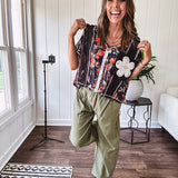 Lightweight black V neck tee with coral rose floral print throughout, raw seams and black ace inserts and ivory floral crochet patchwork on the front pocket.