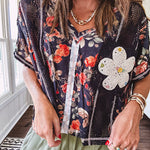 Lightweight black V neck tee with coral rose floral print throughout, raw seams and black ace inserts and ivory floral crochet patchwork on the front pocket.