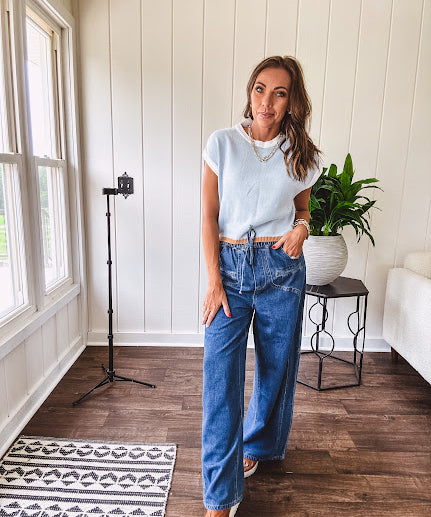 Light washed wide leg denim with front pockets, unique seam detail down the legs and drawstring waist.