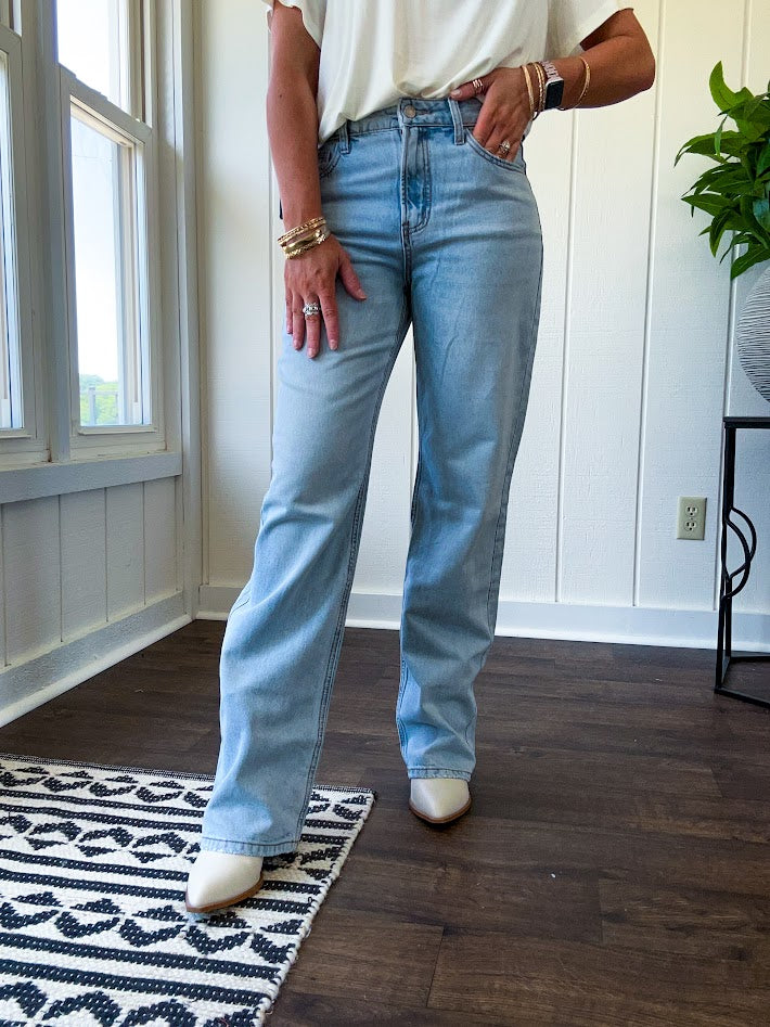 Light wash 90s dad jean with zero distressing and relaxed, straight leg design, finished hem.