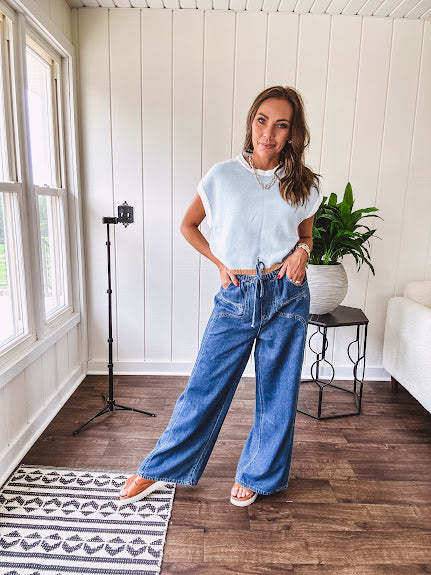 Light washed wide leg denim with front pockets, unique seam detail down the legs and drawstring waist.