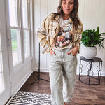 Mineral washed light olive denim barrel pants with carpenter design, side pockets and button and zipper closure with elastic back waist.