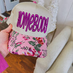Structured trucker hat with canvas background, orchid "homebody" in thick embroidery and a floral bill.