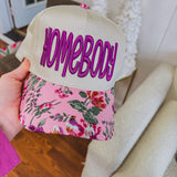 Structured trucker hat with canvas background, orchid "homebody" in thick embroidery and a floral bill.