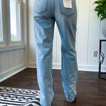 Light wash 90s dad jean with zero distressing and relaxed, straight leg design, finished hem.
