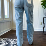 Light wash 90s dad jean with zero distressing and relaxed, straight leg design, finished hem.