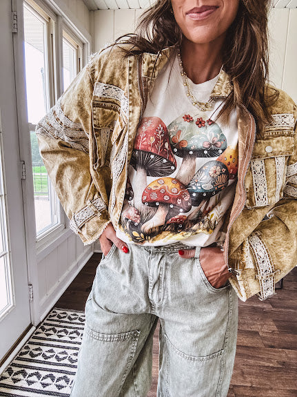Soft oatmeal tee with retro inspired mushrooms in washed teal, red, spice and yellow with florals throughout and dotted with rhinestones.