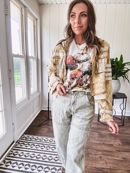 Soft oatmeal tee with retro inspired mushrooms in washed teal, red, spice and yellow with florals throughout and dotted with rhinestones.