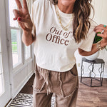Ivory cotton tee featuring dark brown "Out of Office" and "Needing a Little Me Time Rest & Relaxation Office the Cock, 'bye!" graphics on the front and back.