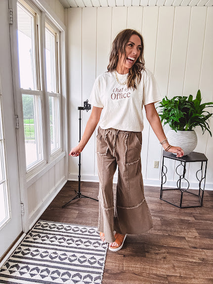 Cotton terry wide leg pants in medium brown with wide legs, exposed seams throughout, elastic drawstring waist and oversized pockets.