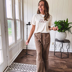 Cotton terry wide leg pants in medium brown with wide legs, exposed seams throughout, elastic drawstring waist and oversized pockets.
