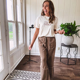 Cotton terry wide leg pants in medium brown with wide legs, exposed seams throughout, elastic drawstring waist and oversized pockets.