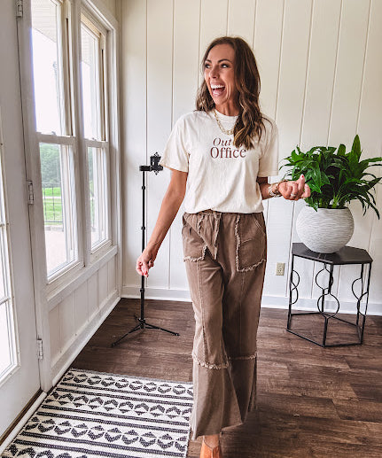 Cotton terry wide leg pants in medium brown with wide legs, exposed seams throughout, elastic drawstring waist and oversized pockets.