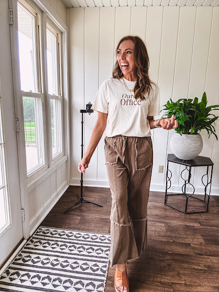 Cotton terry wide leg pants in medium brown with wide legs, exposed seams throughout, elastic drawstring waist and oversized pockets.