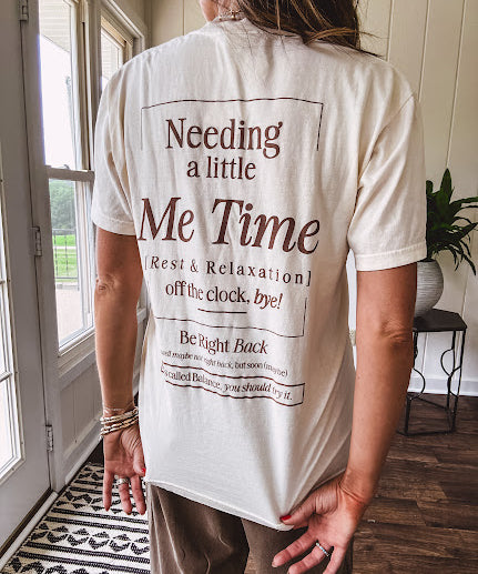 Ivory cotton tee featuring dark brown "Out of Office" and "Needing a Little Me Time Rest & Relaxation Office the Cock, 'bye!" graphics on the front and back.