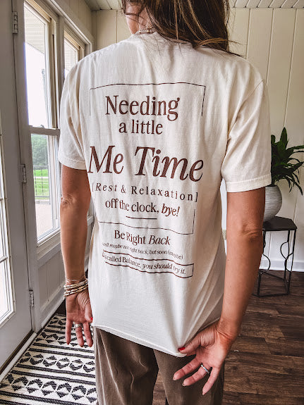 Ivory cotton tee featuring dark brown "Out of Office" and "Needing a Little Me Time Rest & Relaxation Office the Cock, 'bye!" graphics on the front and back.
