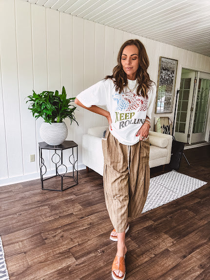 Lightweight mocha utility pant with textured darker mocha striping and contrasting tan and cream mini striping at the elastic drawstring waist and trim on the oversized pocket.