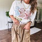 Lightweight mocha utility pant with textured darker mocha striping and contrasting tan and cream mini striping at the elastic drawstring waist and trim on the oversized pocket.