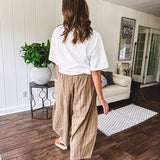 Lightweight mocha utility pant with textured darker mocha striping and contrasting tan and cream mini striping at the elastic drawstring waist and trim on the oversized pocket.