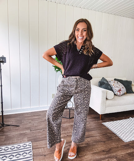 Stretchy camel colored leopard print barrel pants with side pockets, tan trim at the waist, button and zipper closure and relaxed fit.