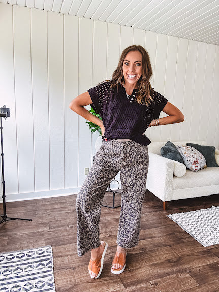 Stretchy camel colored leopard print barrel pants with side pockets, tan trim at the waist, button and zipper closure and relaxed fit.