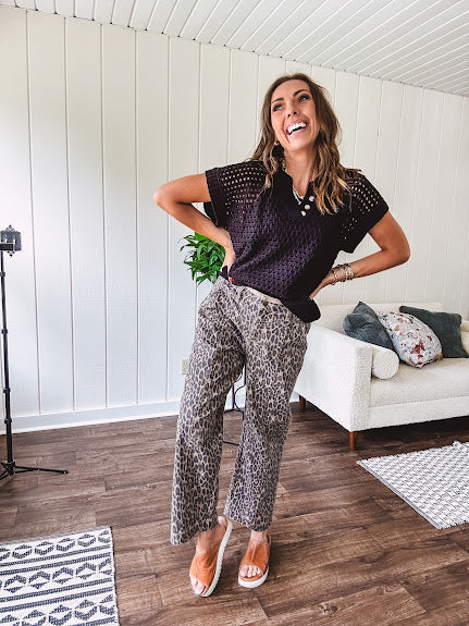 Stretchy camel colored leopard print barrel pants with side pockets, tan trim at the waist, button and zipper closure and relaxed fit.
