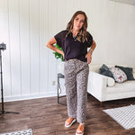 Stretchy camel colored leopard print barrel pants with side pockets, tan trim at the waist, button and zipper closure and relaxed fit.