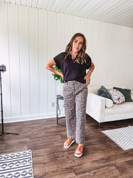 Stretchy camel colored leopard print barrel pants with side pockets, tan trim at the waist, button and zipper closure and relaxed fit.