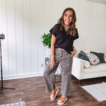 Stretchy camel colored leopard print barrel pants with side pockets, tan trim at the waist, button and zipper closure and relaxed fit.