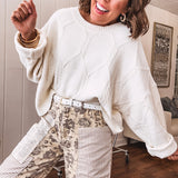 khaki and grey floral denim wide leg pants with an elastic waist, paired with delicate crochet lace and khaki striped patches with a button and zipper closure.