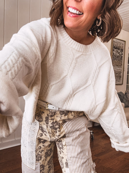 Ivory cable knit cropped sweater.