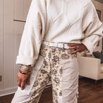khaki and grey floral denim wide leg pants with an elastic waist, paired with delicate crochet lace and khaki striped patches with a button and zipper closure.