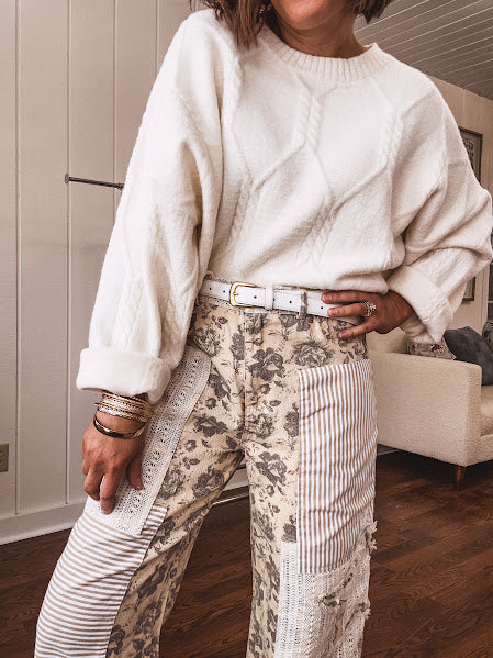 khaki and grey floral denim wide leg pants with an elastic waist, paired with delicate crochet lace and khaki striped patches with a button and zipper closure.