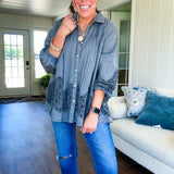 Lightweight washed long sleeved button down top with pleating at the yoke, lace detail on the sleeves and above the hem and elastic cuffs, flowy design.