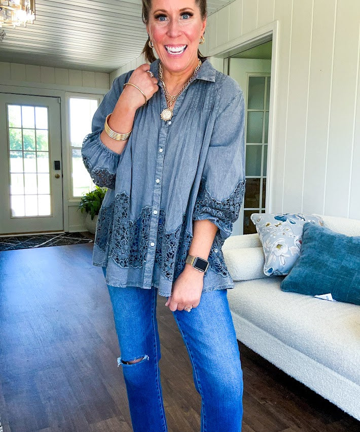 Lightweight washed long sleeved button down top with pleating at the yoke, lace detail on the sleeves and above the hem and elastic cuffs, flowy design.