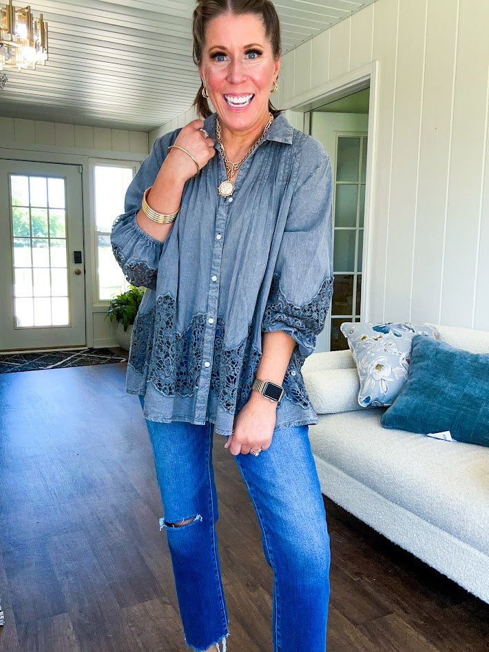 Lightweight washed long sleeved button down top with pleating at the yoke, lace detail on the sleeves and above the hem and elastic cuffs, flowy design.