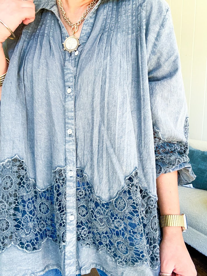 Lightweight washed long sleeved button down top with pleating at the yoke, lace detail on the sleeves and above the hem and elastic cuffs, flowy design.