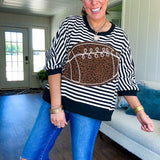 Soft, terry-like black and white striped half sleeve top with oversized leopard print football applique on the front, black trim at the round neck, cuffs and wide hem.