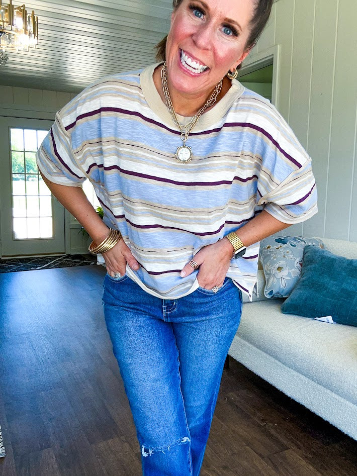 Taupe, light blue, mulberry and cream striped lightweight short sleeved tee with taupe trim at the round neck and seams and a boxy cut.