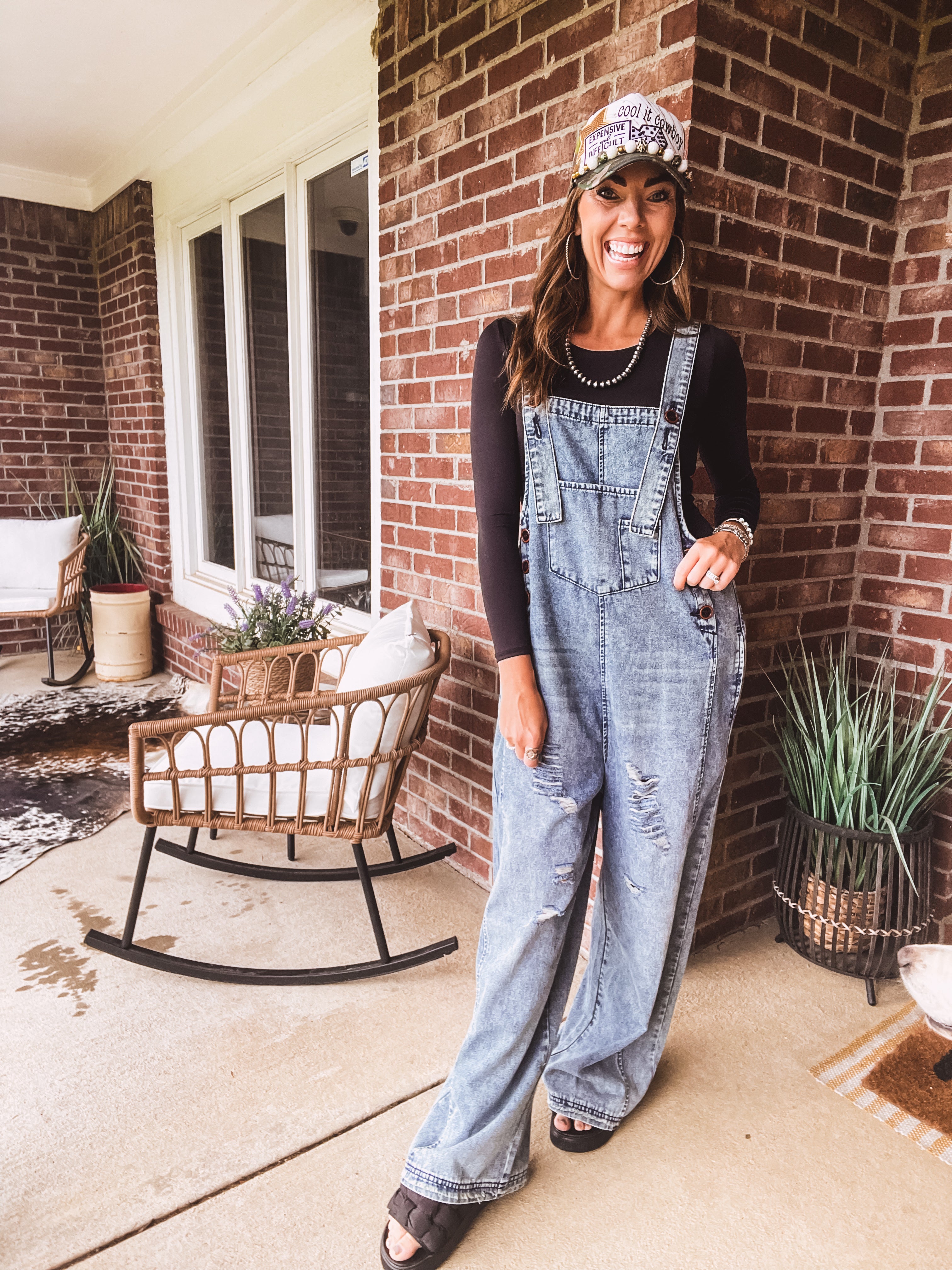 Loose fit medium wash denim overalls with adjustable button straps and sides and distressing throughout.
