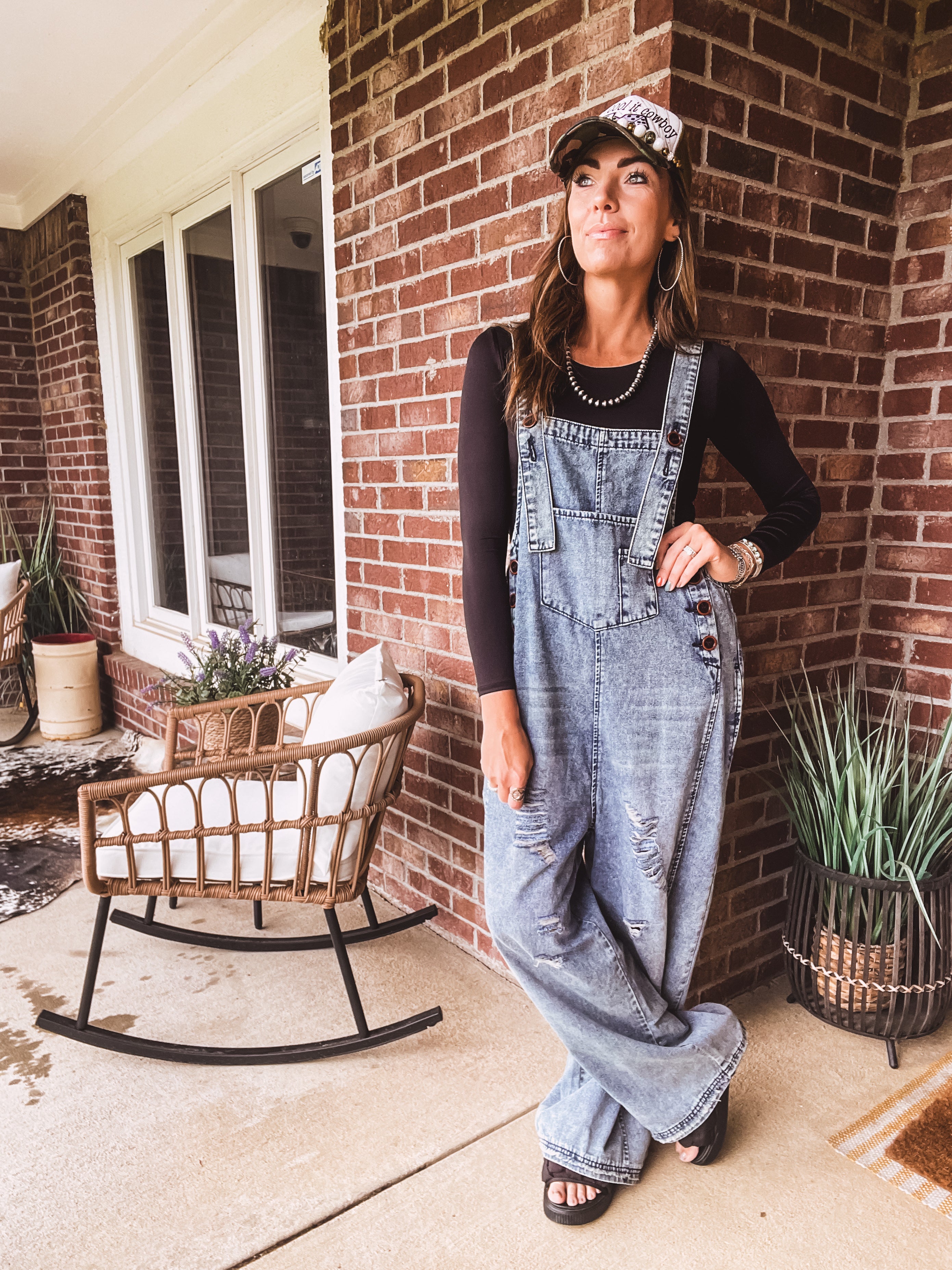 Loose fit medium wash denim overalls with adjustable button straps and sides and distressing throughout.