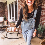 Loose fit medium wash denim overalls with adjustable button straps and sides and distressing throughout.