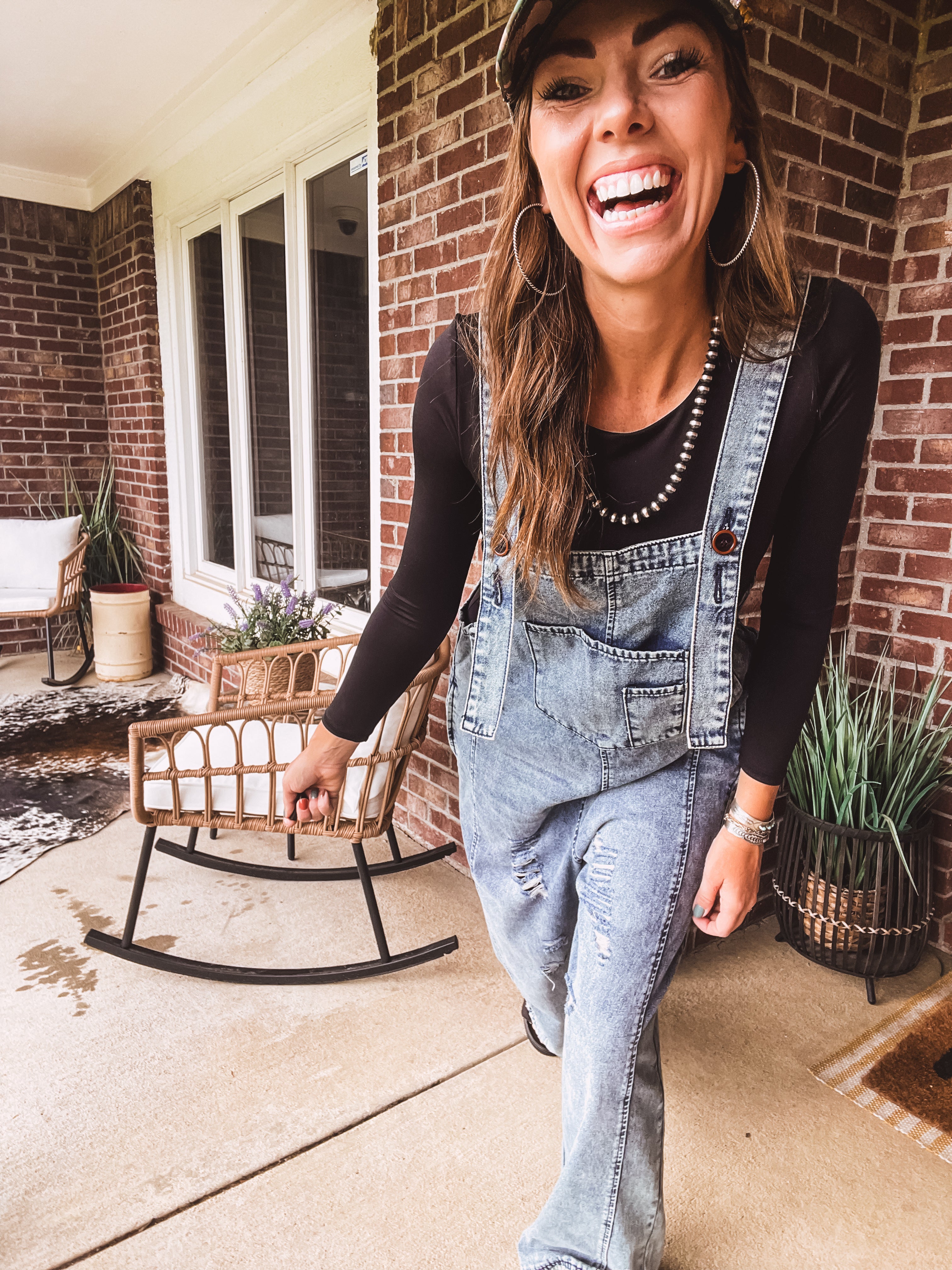 Loose fit medium wash denim overalls with adjustable button straps and sides and distressing throughout.