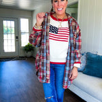 Cream long sleeved sweater with round neck and red trim at neck an cuffs with American Flag motif.