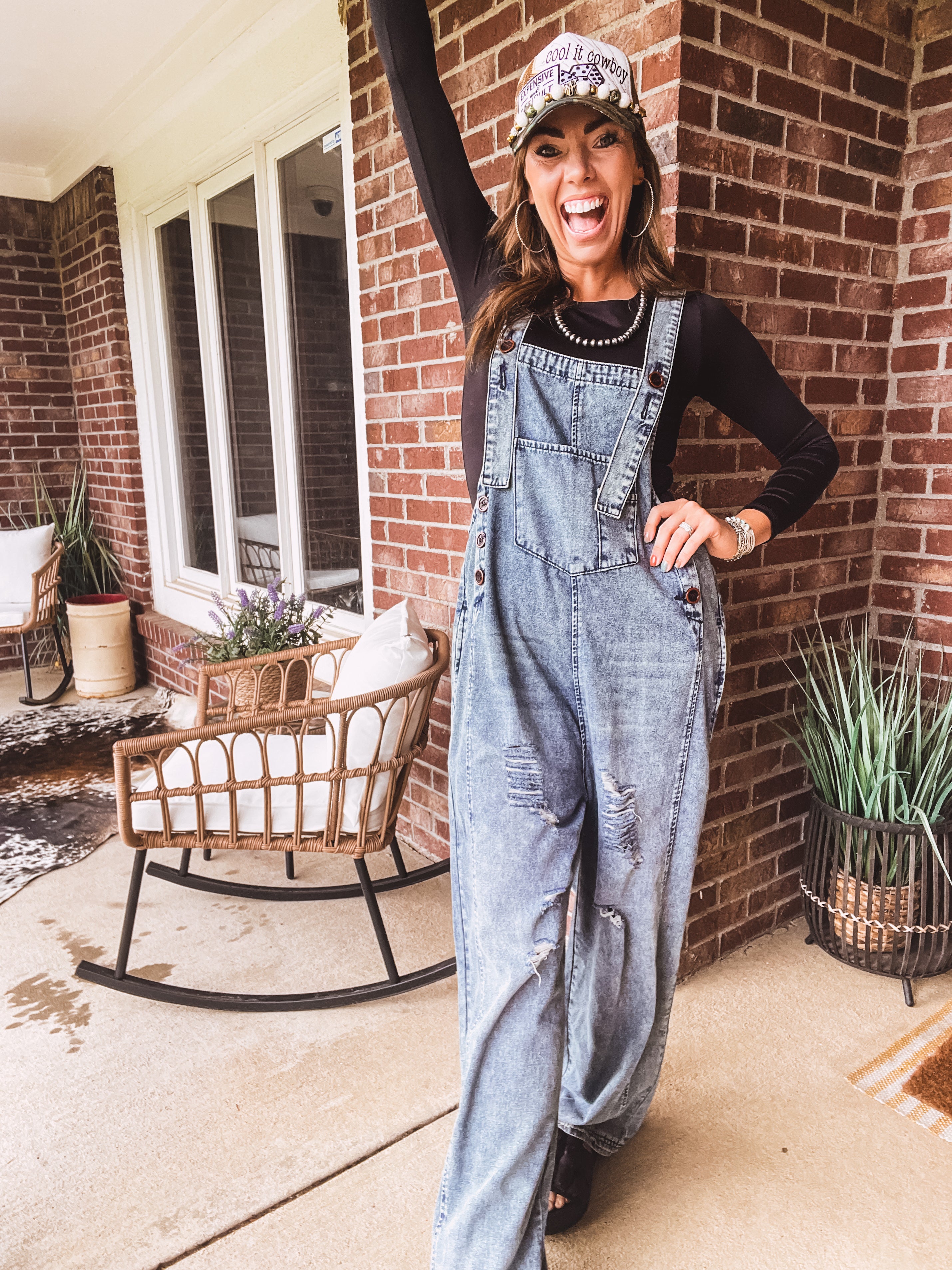 Loose fit medium wash denim overalls with adjustable button straps and sides and distressing throughout.