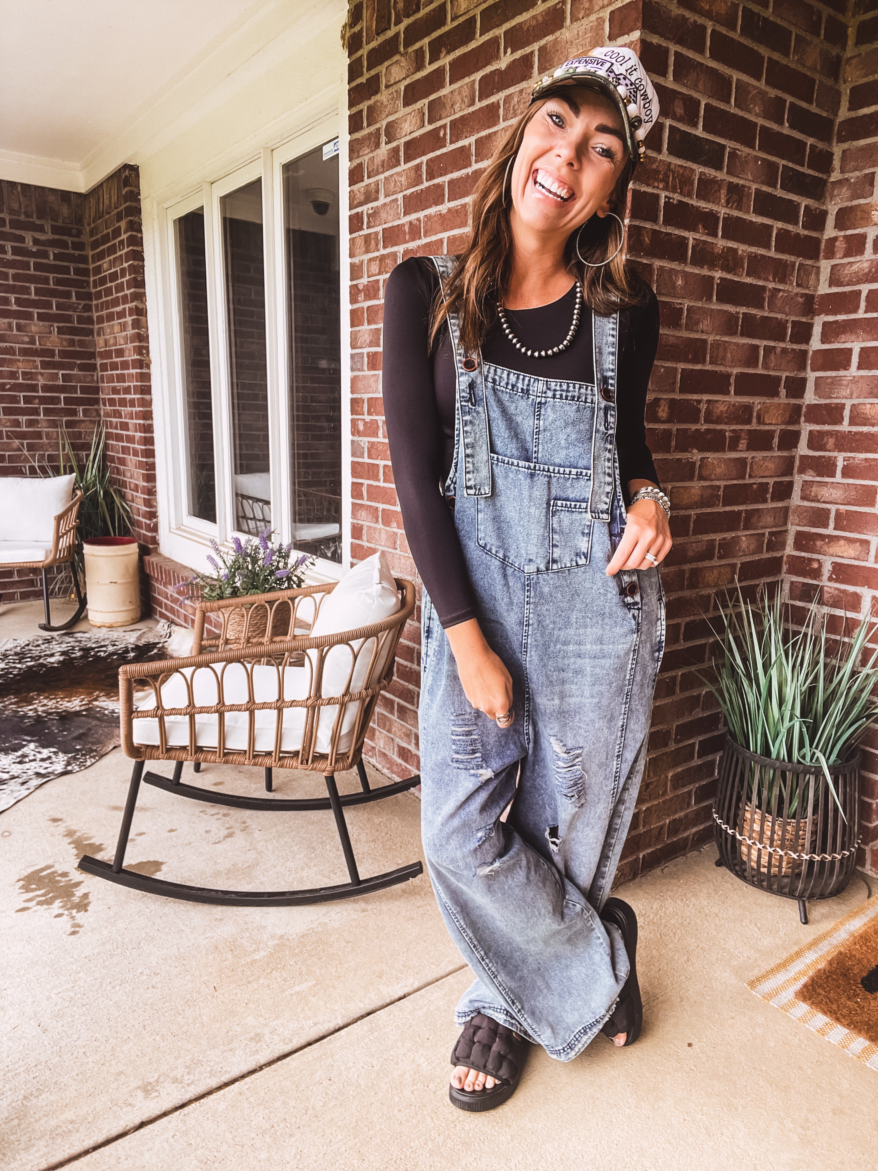Loose fit medium wash denim overalls with adjustable button straps and sides and distressing throughout.