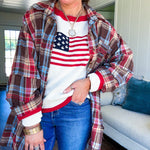 Cream long sleeved sweater with round neck and red trim at neck an cuffs with American Flag motif.