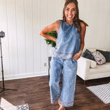 Light wash denim set that's equal parts effortless and eye-catching. The tank features a hook-and-eye neck closure and loose hem, while caramel embroidered stitching adds personality throughout. Pair it with the matching wide-leg pants—complete with button-zip closure, elastic back waist, front and side pleating, and pockets lined with the same playful embroidered detail.